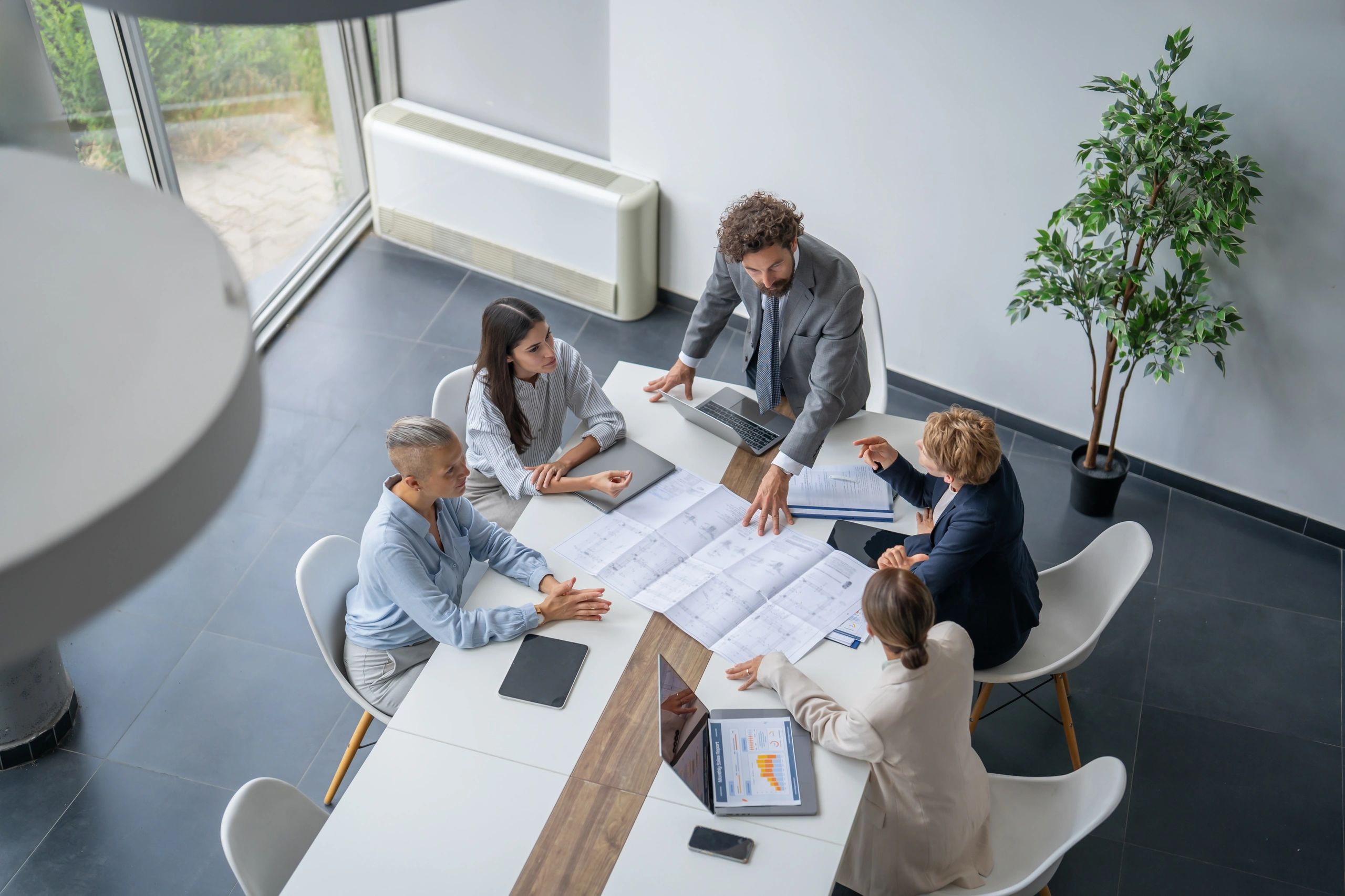 Construction professionals reviewing blueprints in an office